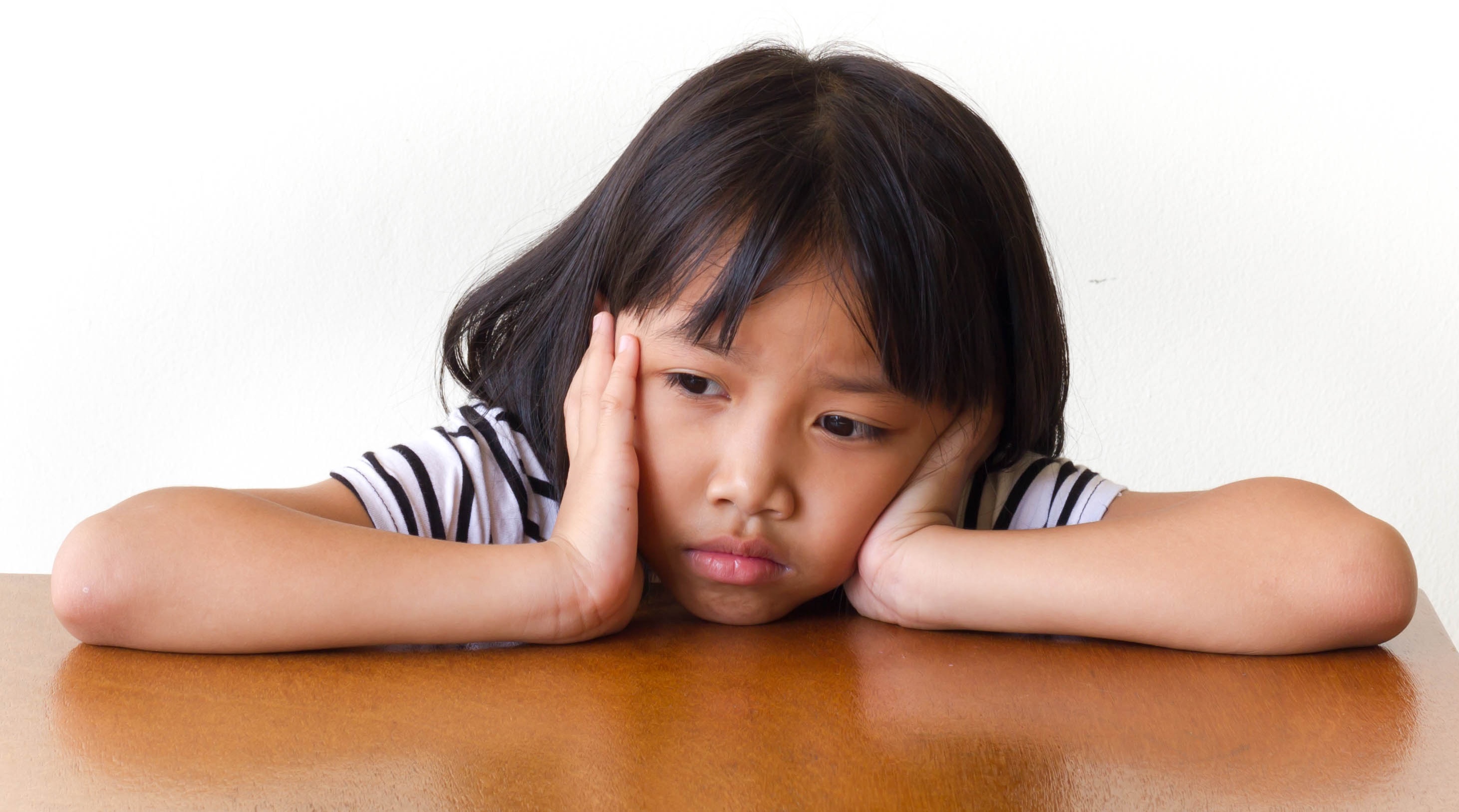 Dejected little girl at table Dejected little girl at table